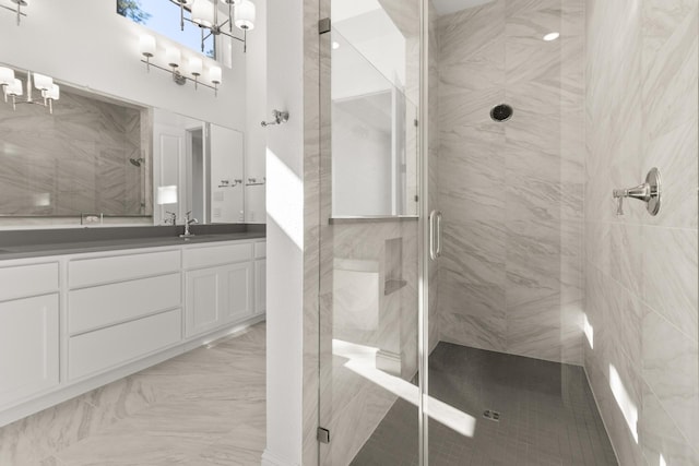 bathroom featuring a stall shower, marble finish floor, vanity, and a high ceiling