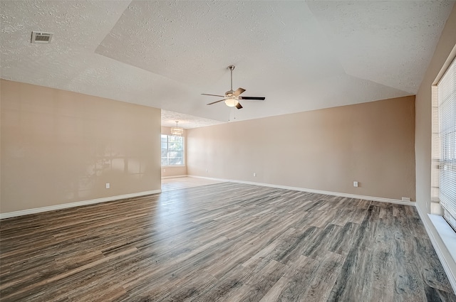 unfurnished room featuring ceiling fan, lofted ceiling, a textured ceiling, and dark wood-type flooring