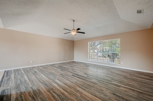 spare room featuring hardwood / wood-style flooring, ceiling fan, a textured ceiling, and vaulted ceiling