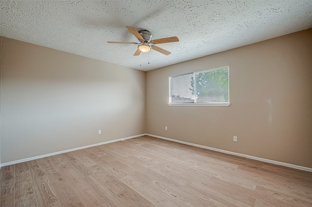 spare room featuring ceiling fan, a textured ceiling, and light hardwood / wood-style flooring