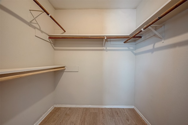 spacious closet with light hardwood / wood-style floors