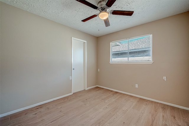 empty room featuring a textured ceiling, light hardwood / wood-style flooring, and ceiling fan