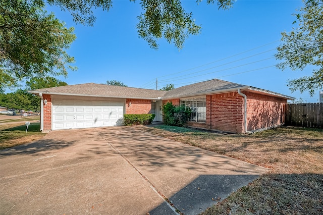 ranch-style house featuring a garage and a front yard