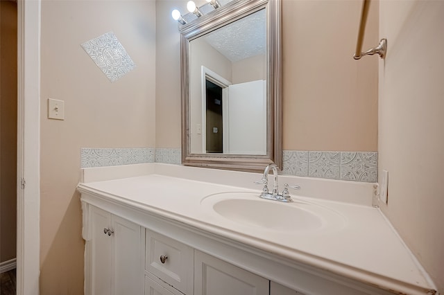 bathroom featuring vanity and a textured ceiling