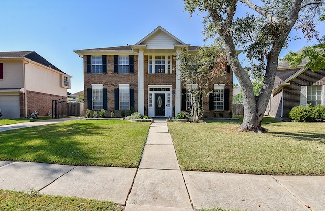 view of front of house featuring a garage and a front lawn