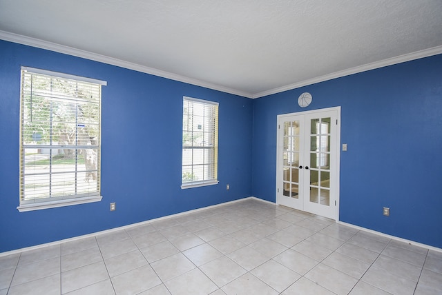 tiled spare room with ornamental molding, french doors, a textured ceiling, and a healthy amount of sunlight