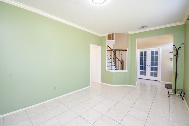 unfurnished room featuring french doors, light tile patterned flooring, and crown molding