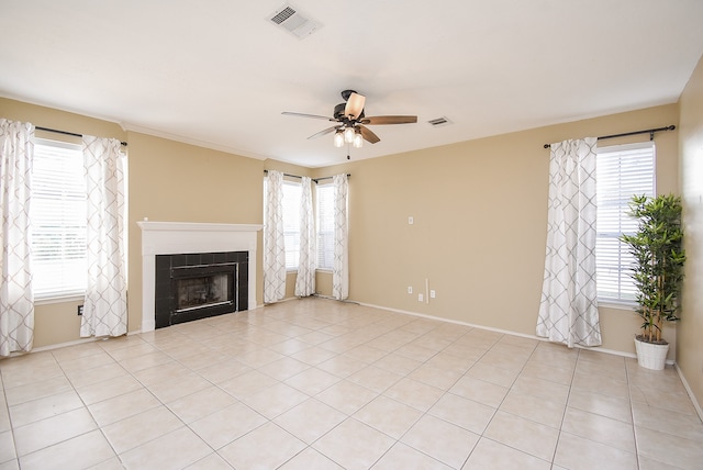 unfurnished living room with light tile patterned floors, a tile fireplace, and ceiling fan