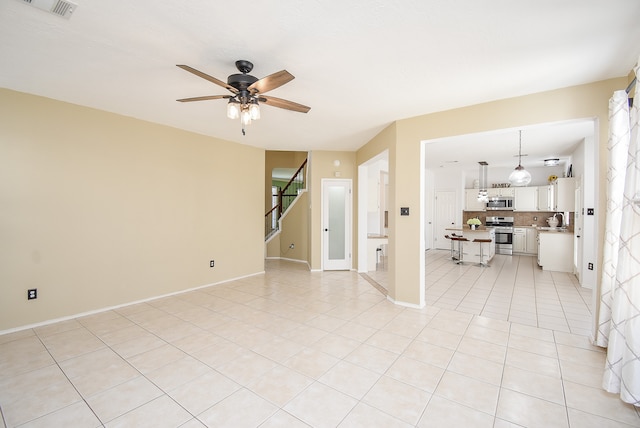 spare room with ceiling fan, sink, and light tile patterned floors