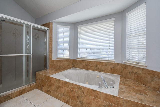 bathroom with lofted ceiling, tile patterned flooring, separate shower and tub, and a wealth of natural light