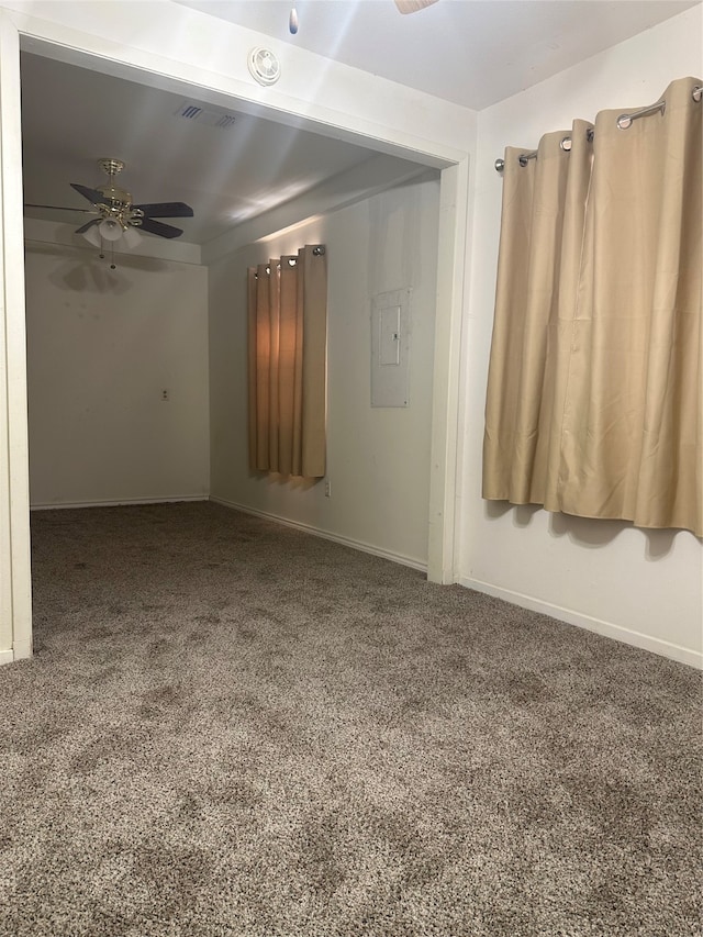 carpeted spare room with ceiling fan