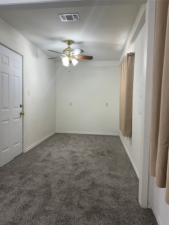 unfurnished room featuring ceiling fan and dark colored carpet