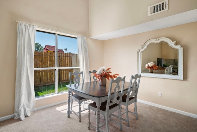 dining room with light colored carpet