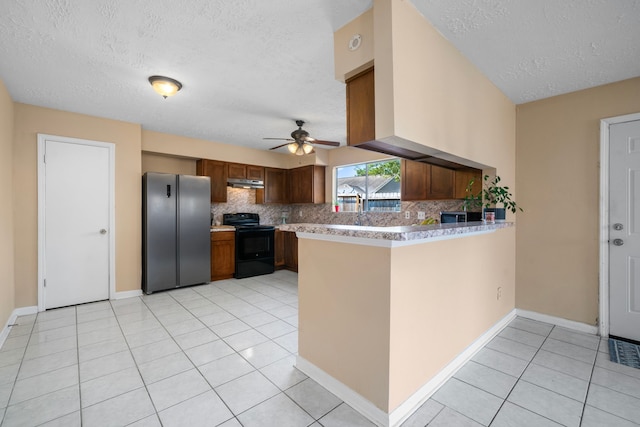 kitchen with stainless steel fridge, kitchen peninsula, tasteful backsplash, a textured ceiling, and black / electric stove