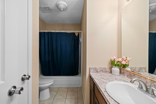 full bathroom featuring vanity, toilet, shower / bath combo, a textured ceiling, and tile patterned flooring