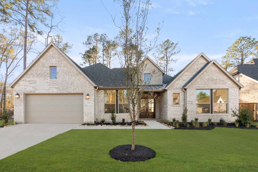 view of front of property with a front lawn and a garage