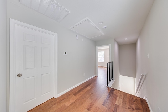 309A De Haven St, Houston, TX 77029 - hallway featuring light wood-style flooring, an upstairs landing, attic access, and baseboards