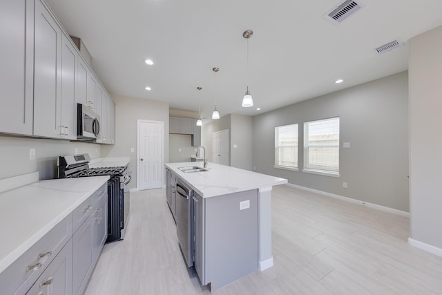 309A De Haven St, Houston, TX 77029 - kitchen with stainless steel appliances, visible vents, a sink, and gray cabinets