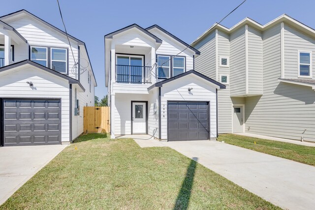 309A De Haven St, Houston, TX 77029 - view of front of property featuring a garage, a front yard, fence, a balcony, and concrete driveway
