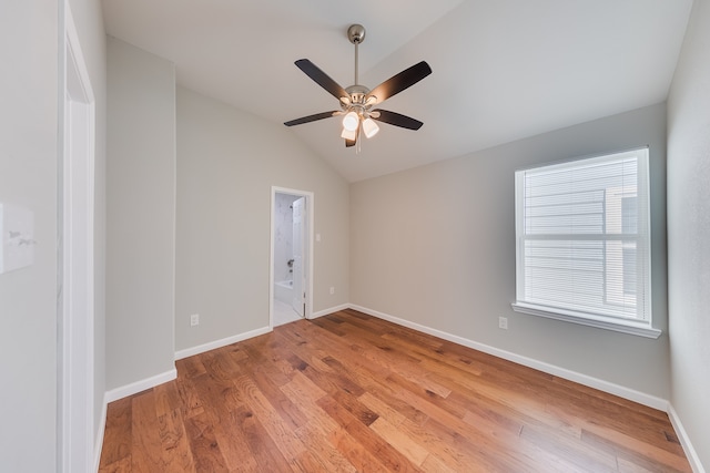 spare room featuring hardwood / wood-style flooring, ceiling fan, and vaulted ceiling