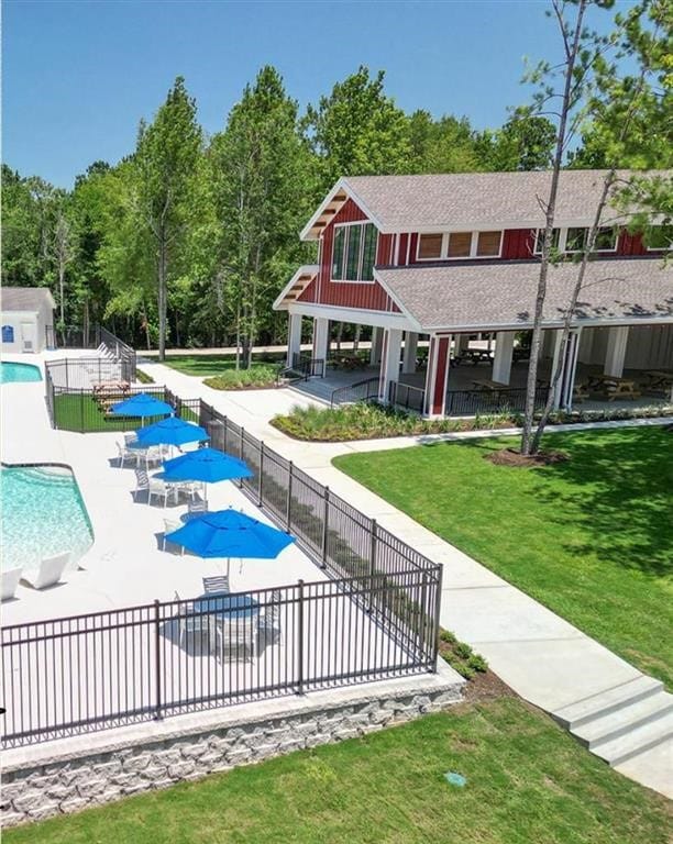 view of pool featuring a patio and a lawn