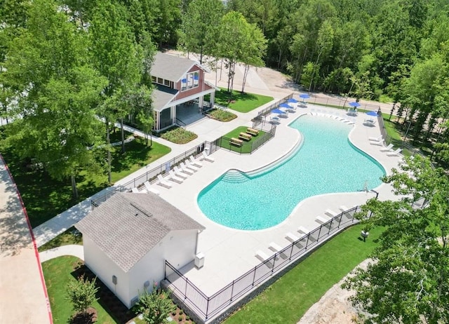 view of swimming pool featuring a patio area and a lawn