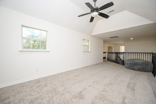 unfurnished room with carpet, ceiling fan, lofted ceiling, and a textured ceiling