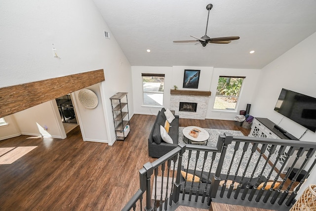 living room with ceiling fan, a healthy amount of sunlight, and vaulted ceiling