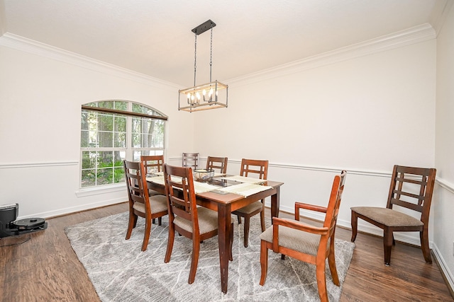 dining area with a chandelier, dark hardwood / wood-style floors, and ornamental molding