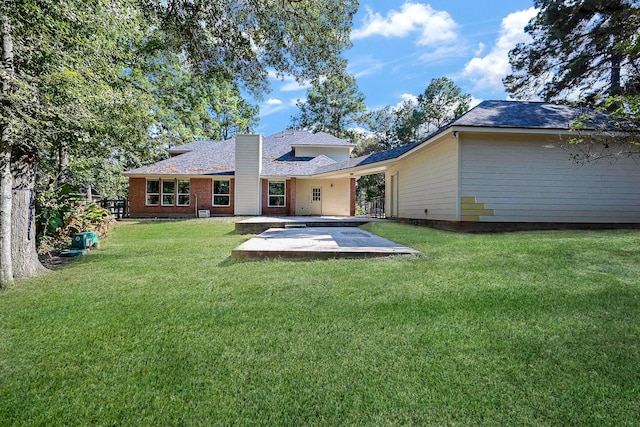 back of property featuring a yard and a patio