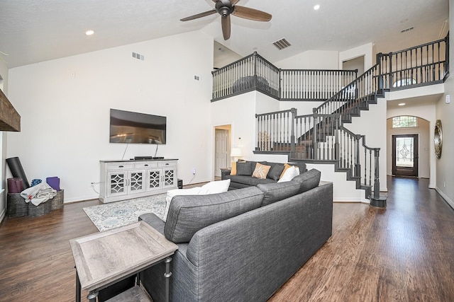 living room featuring high vaulted ceiling, ceiling fan, and dark wood-type flooring