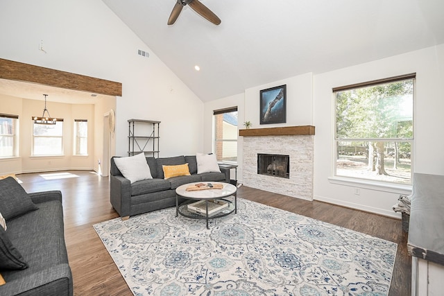 living room featuring a fireplace, high vaulted ceiling, wood-type flooring, and ceiling fan with notable chandelier