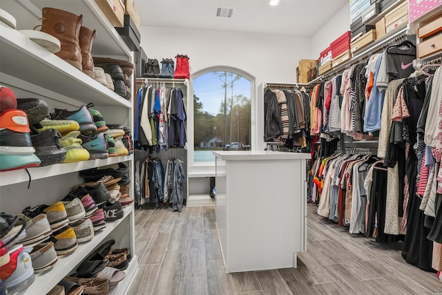 spacious closet with light hardwood / wood-style floors