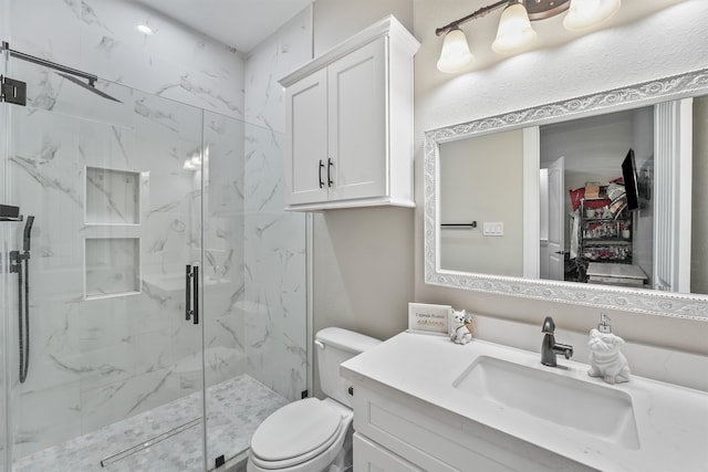 bathroom with an enclosed shower, vanity, and toilet