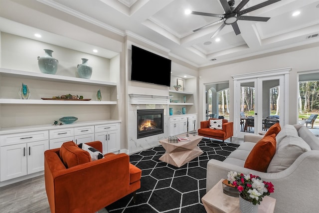 living room with beamed ceiling, dark hardwood / wood-style flooring, a fireplace, coffered ceiling, and ornamental molding