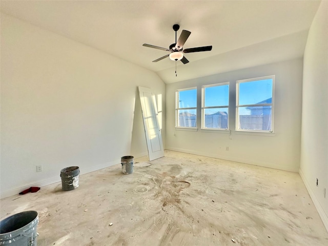 empty room featuring lofted ceiling and ceiling fan