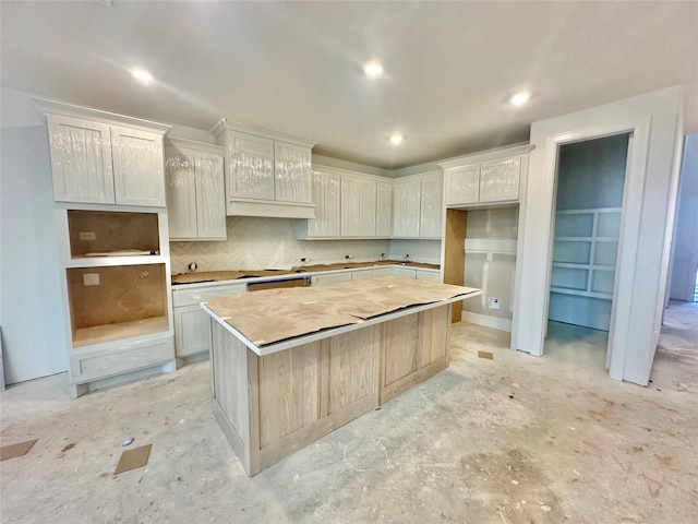 kitchen featuring white cabinetry, tasteful backsplash, and a center island