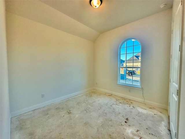 spare room with lofted ceiling