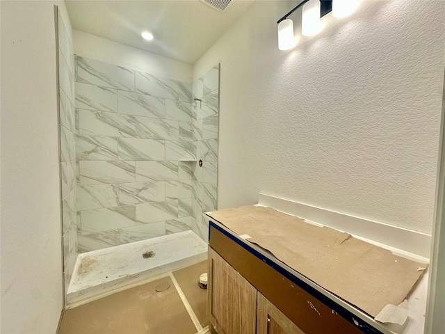 bathroom with tiled shower