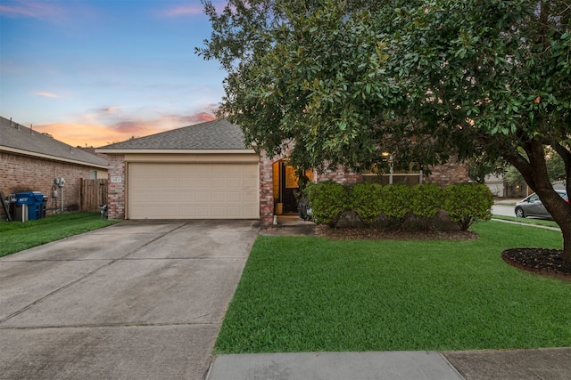 view of front of home with a yard and a garage