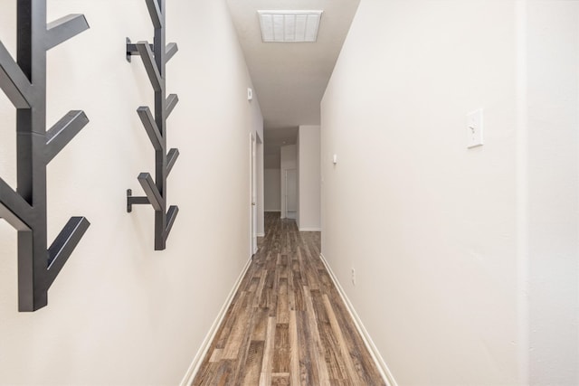 corridor with hardwood / wood-style floors