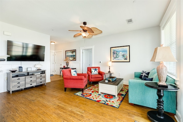 living room with ceiling fan and light hardwood / wood-style floors