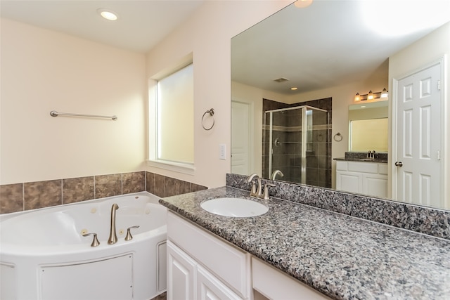 bathroom with vanity and independent shower and bath