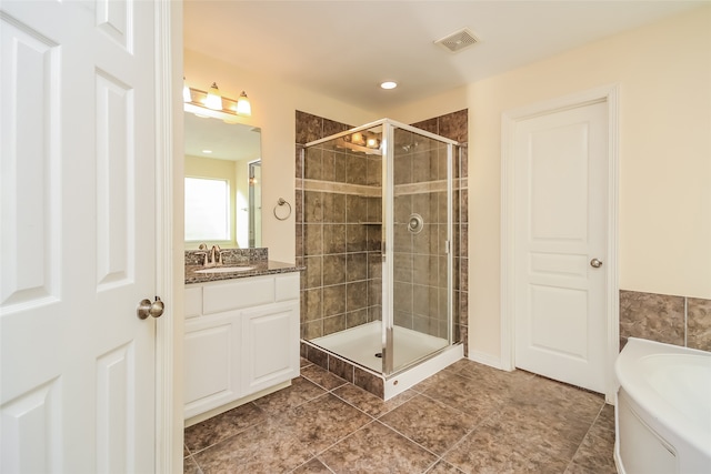 bathroom featuring vanity, shower with separate bathtub, and tile patterned floors