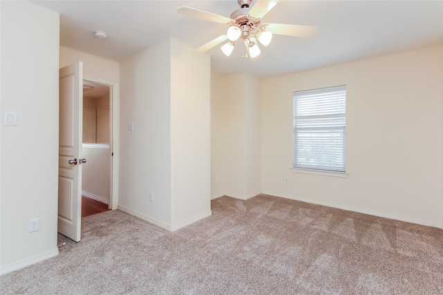 carpeted spare room with ceiling fan