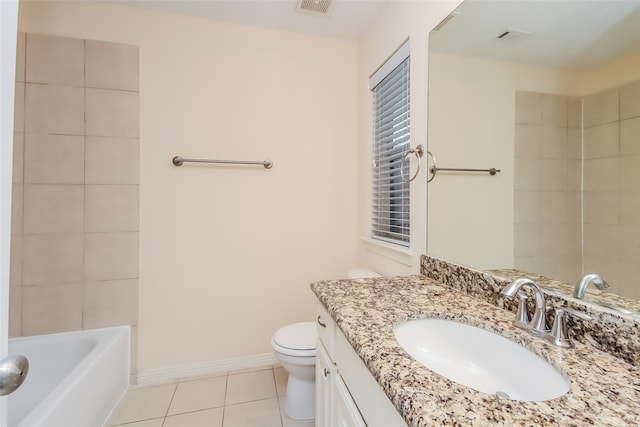 full bathroom featuring tiled shower / bath, vanity, toilet, and tile patterned flooring