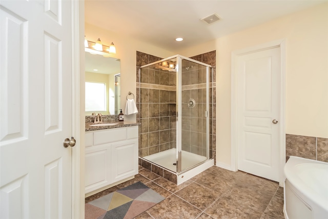 bathroom featuring vanity, shower with separate bathtub, and tile patterned flooring