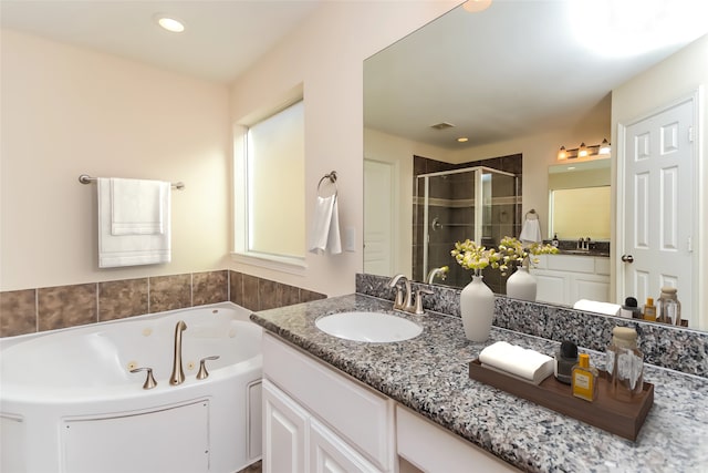 bathroom featuring vanity and separate shower and tub