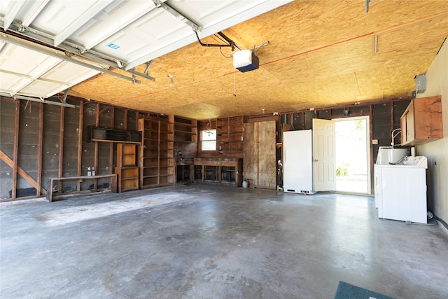 garage featuring washer / dryer, a garage door opener, water heater, and white fridge