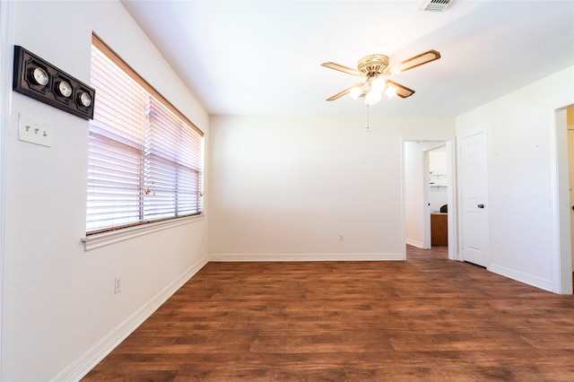 unfurnished room with dark wood-type flooring and ceiling fan